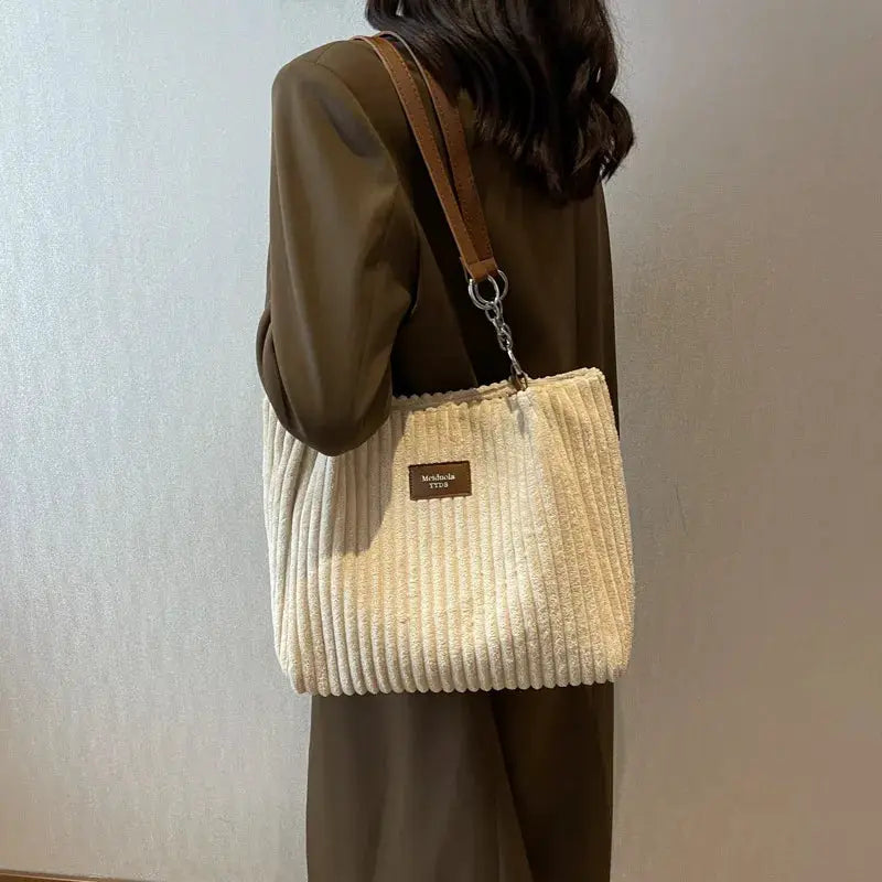 Women corduroy shoulder bag by Simples Market; cream color, fixed shoulder strap, large-capacity casual handbag.