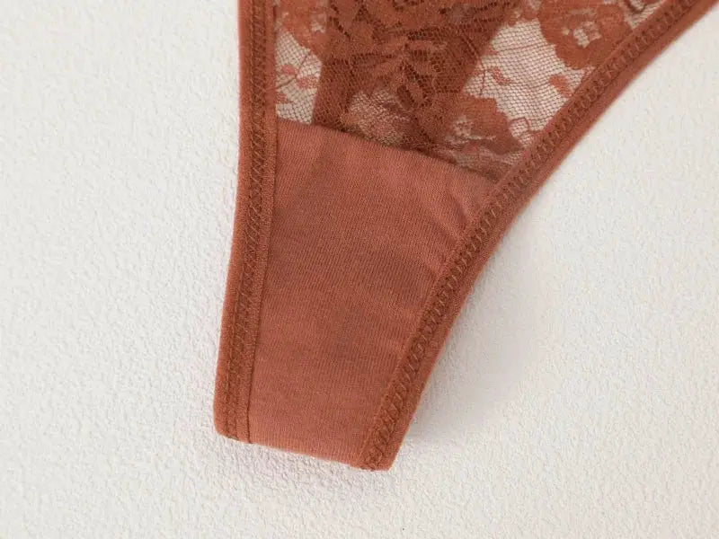 G-string thong in brown lace with floral pattern and solid panel.