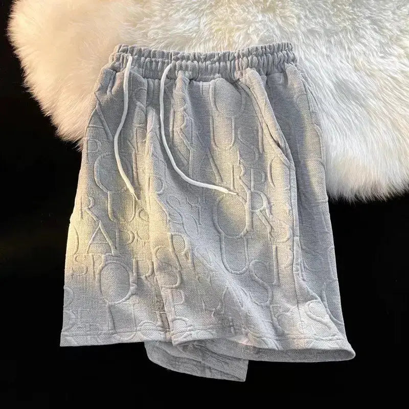 Men's waffle-textured shorts in grey with drawstring waist, loose wide-leg fit for beach and casual wear