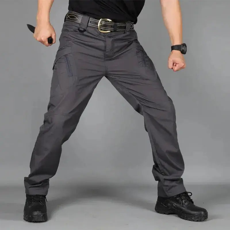Military tactical cargo pants for men, dark gray water-resistant outdoor trousers with multiple pockets.