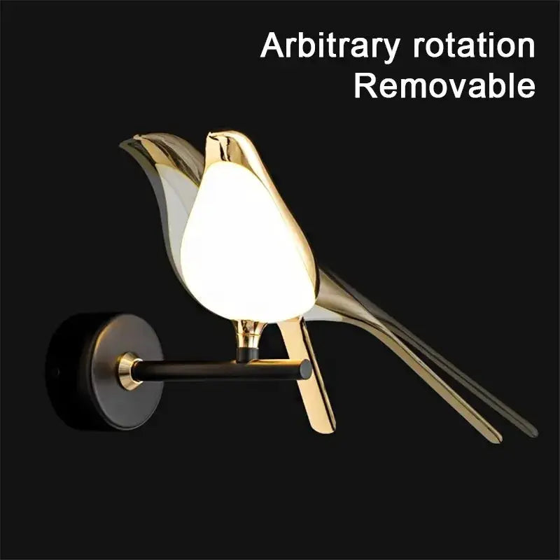 Magpie bird LED wall lamp; modern gold-tone metal wall sconce with white glass shade.