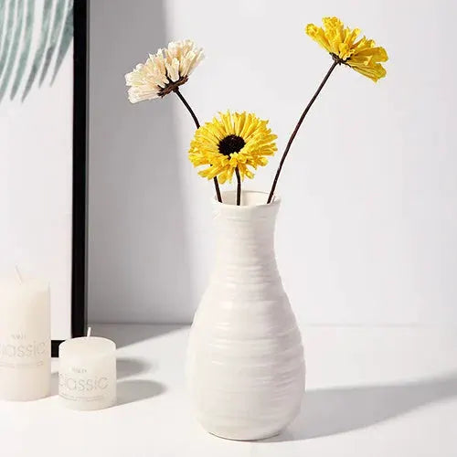 Nordic white plastic vase with ribbed finish holding three flower stems