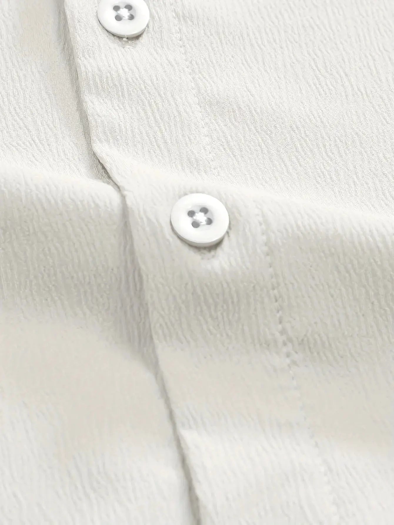 Cream linen button-front shirt with textured fabric and white buttons