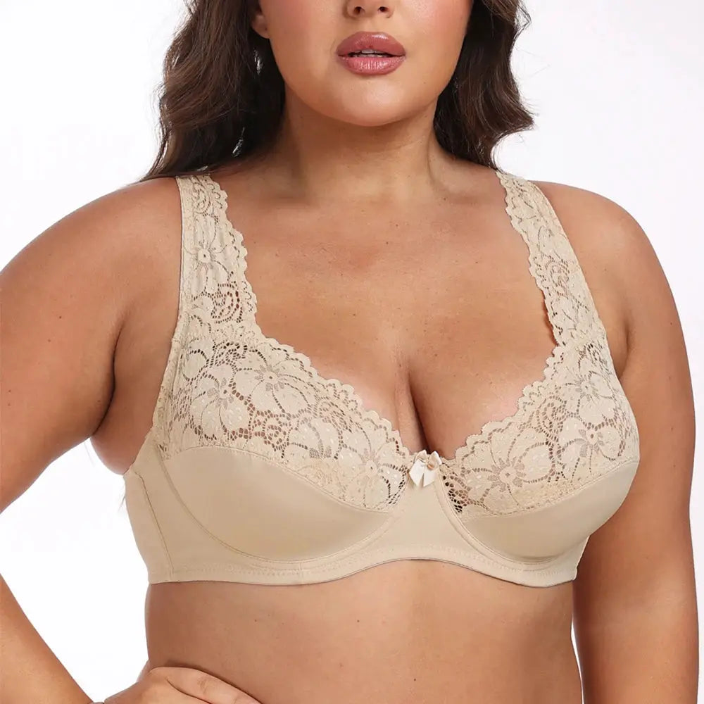 Plus-size beige lace underwire bra with scalloped cups and a small front bow.