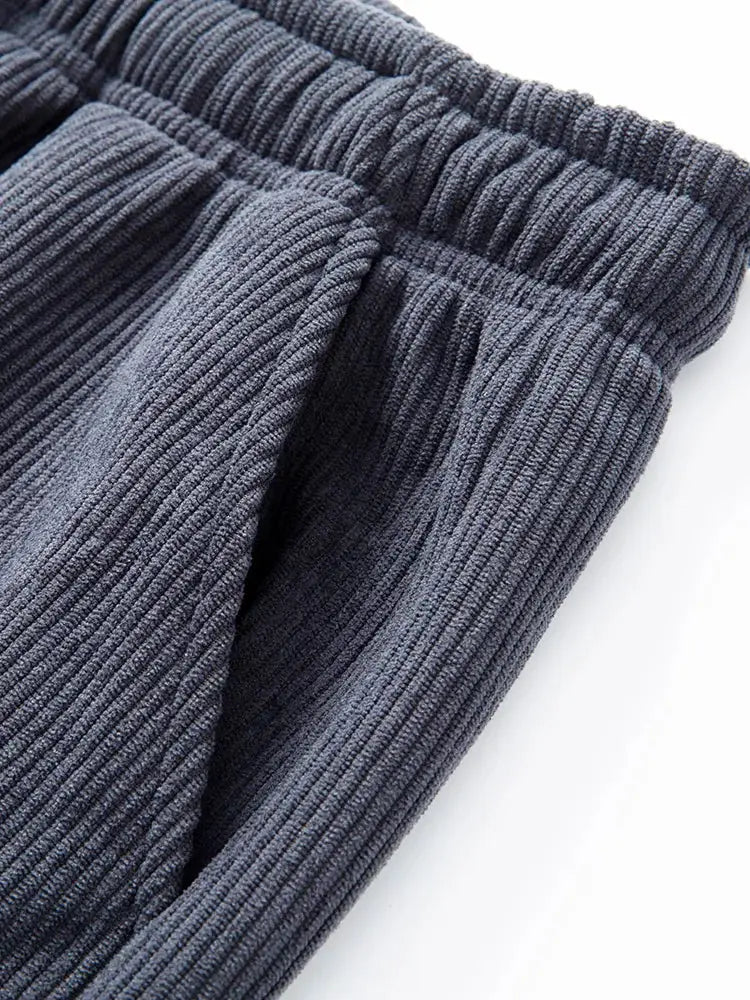 Dark gray corduroy sweatpants with elastic waistband and ribbed texture.