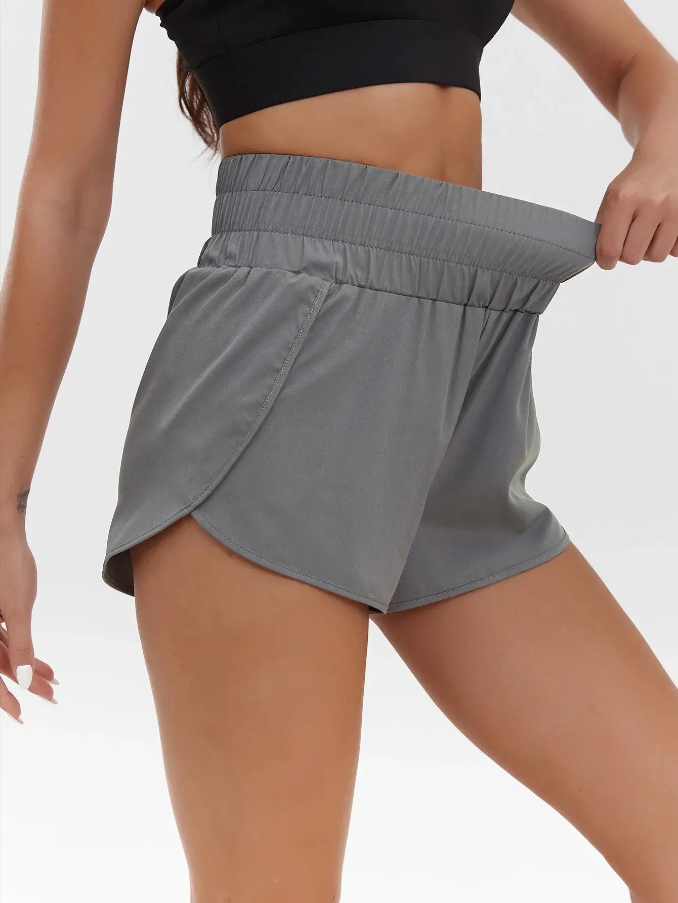 Women's gray high-waist athletic shorts with elastic waistband and curved hem