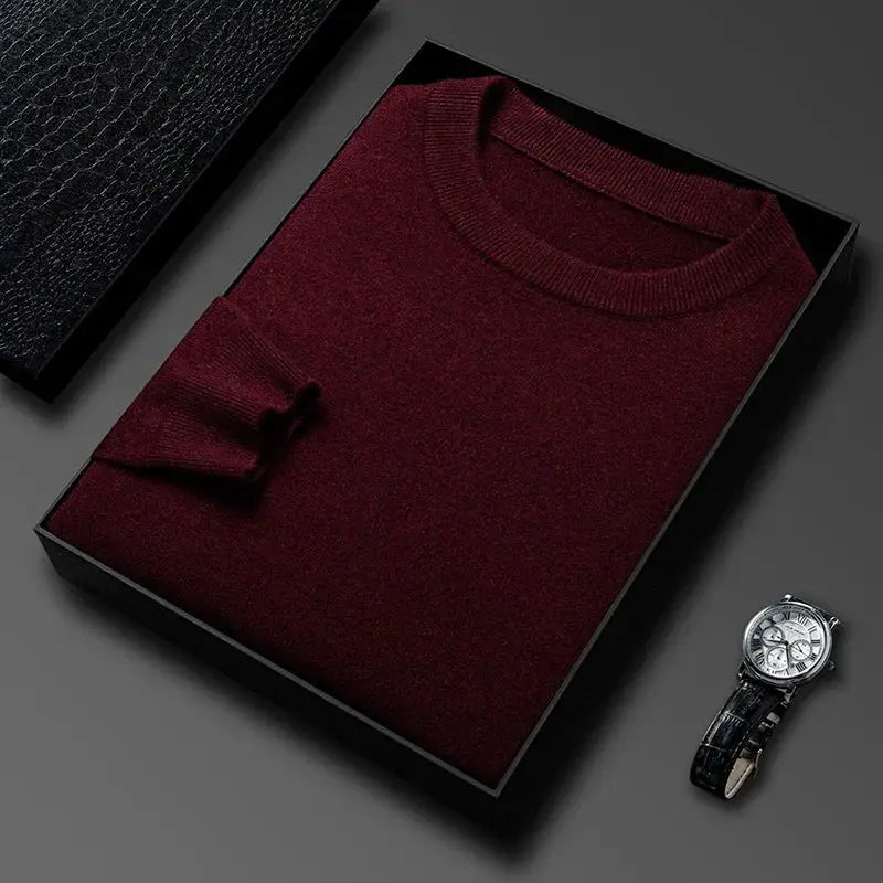Men's maroon knitted sweater folded in a black gift box with a wristwatch beside.