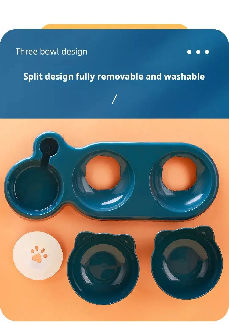 Blue three-bowl pet feeder set with removable bowls and paw-print lid on orange background