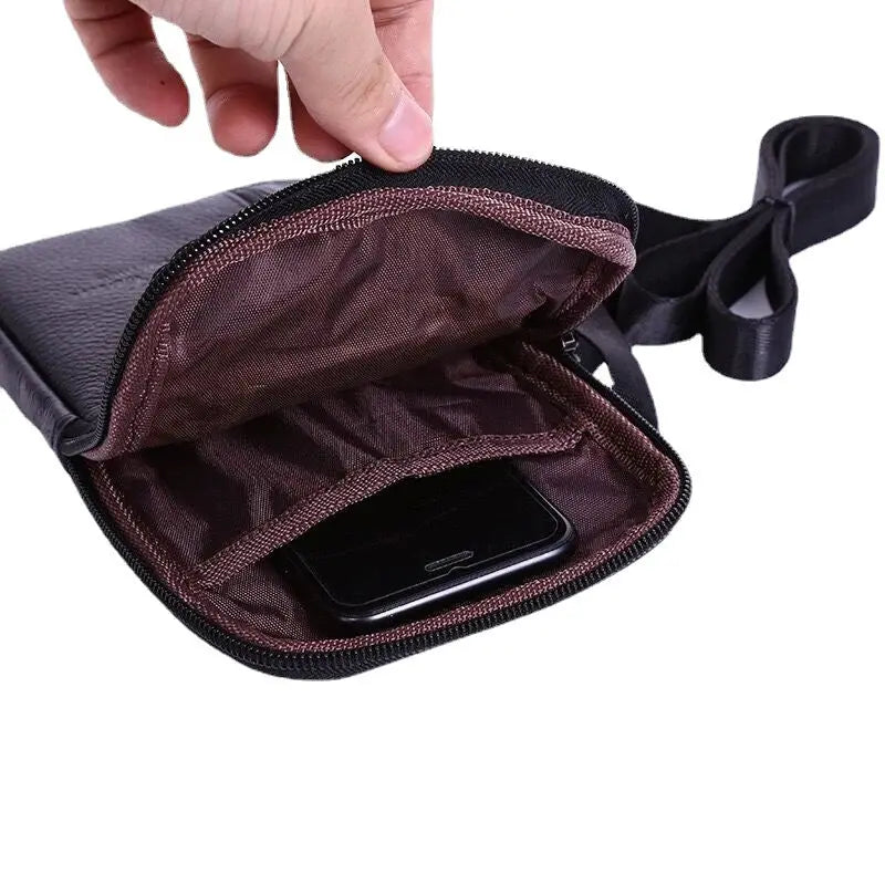 Genuine leather waist bag for men with phone pouch; black exterior, brown interior, compact crossbody design