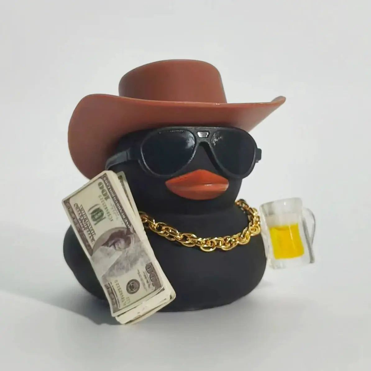 Cowboy rubber duck car ornament; black duck with brown hat and sunglasses, gold chain, cash and beer mug