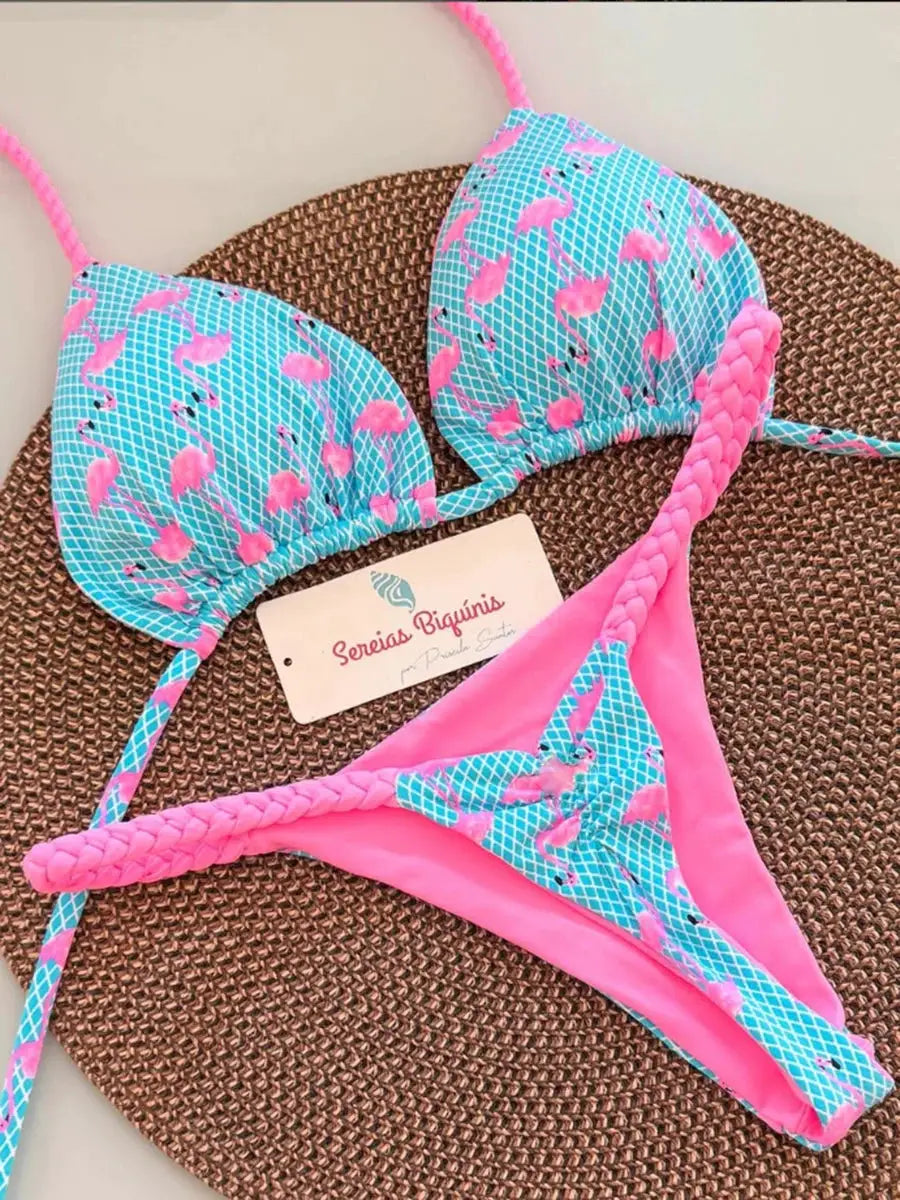 Bikini set by Sereias Biquínis in turquoise with pink flamingos; halter top and thong bottoms with braided straps