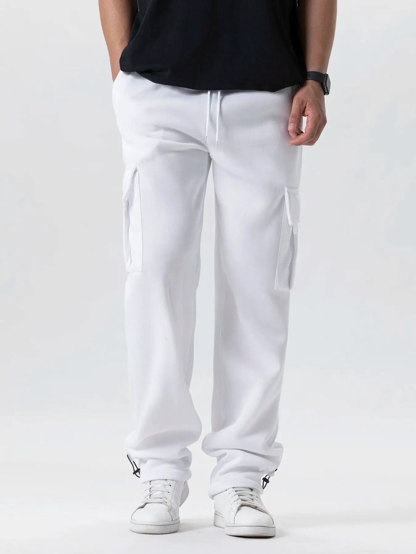 Mens white cargo joggers with drawstring waist, oversized fit and multiple pockets, streetwear style.
