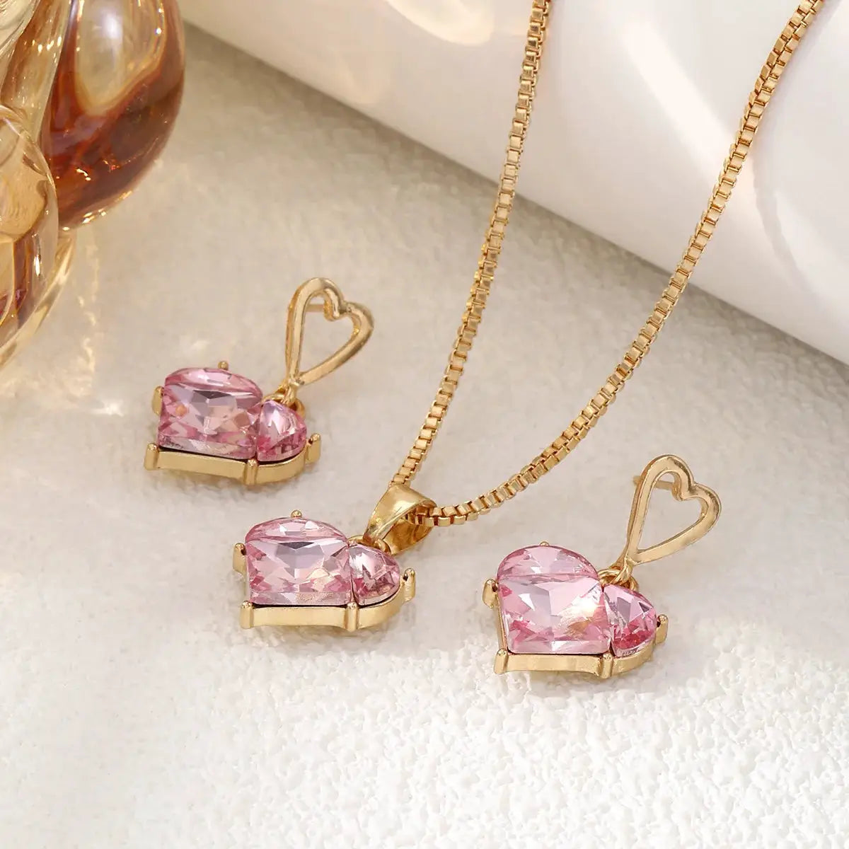 Peach heart necklace and matching earrings set in gold-tone zinc alloy with pink crystals