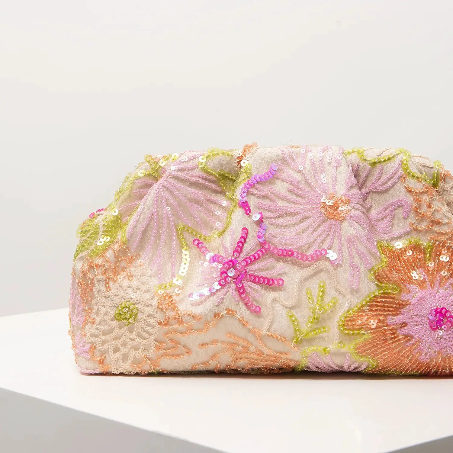 Simples Market floral sequin-embroidery clutch bag in pastel pink, yellow, and peach.
