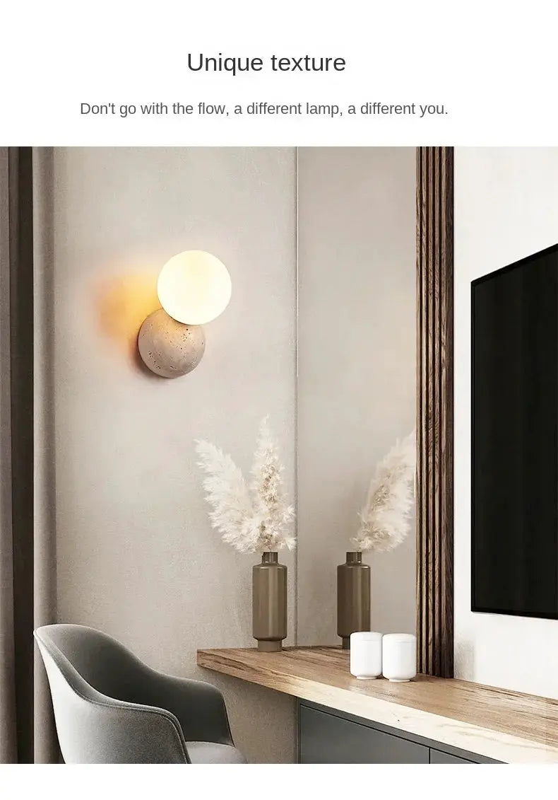 Cream-style LED wall lamp with a glowing round orb above a stone-textured base, wall-mounted bedroom accent.