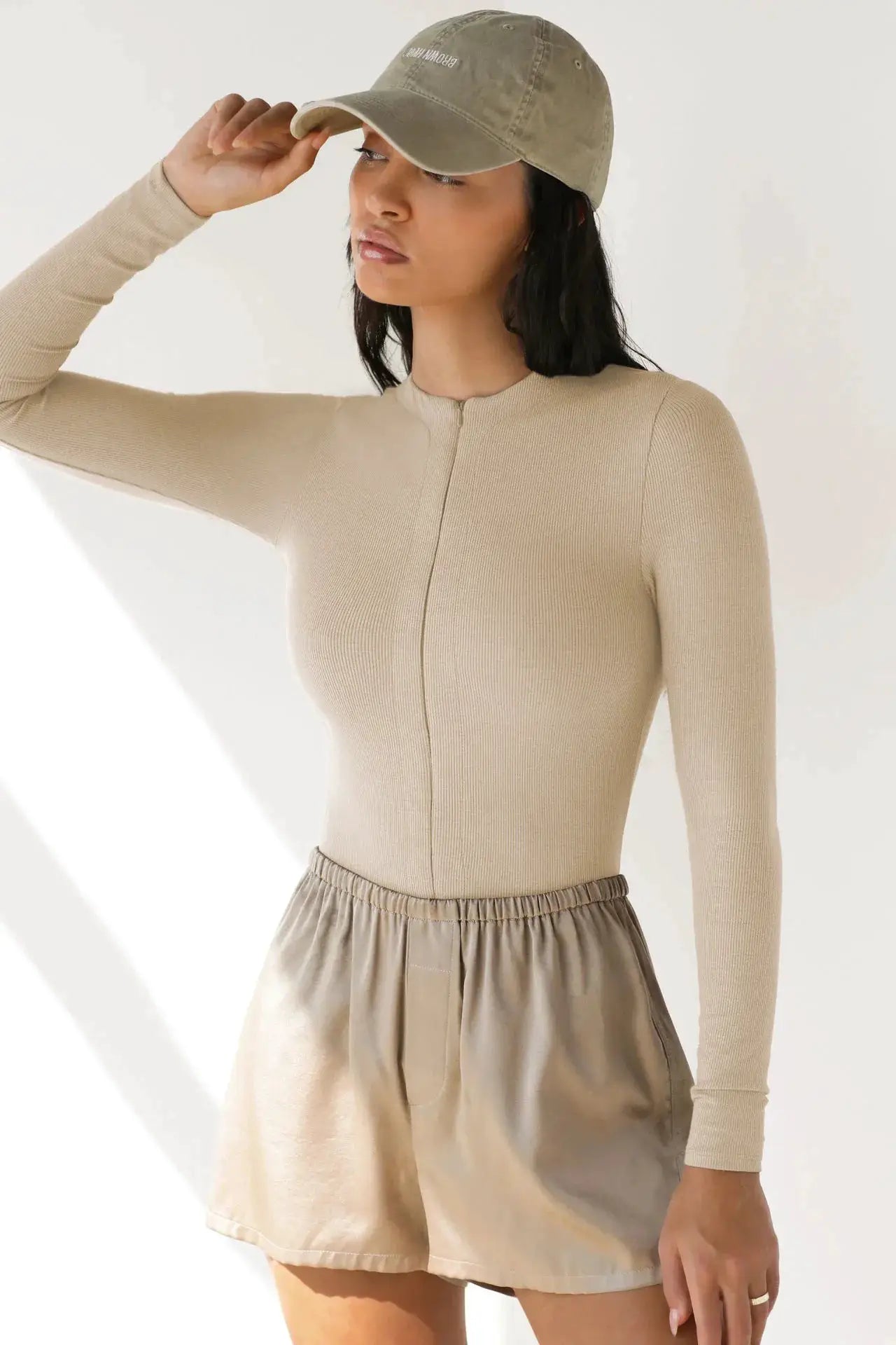 Beige ribbed knit jumpsuit with front zipper, tight fit