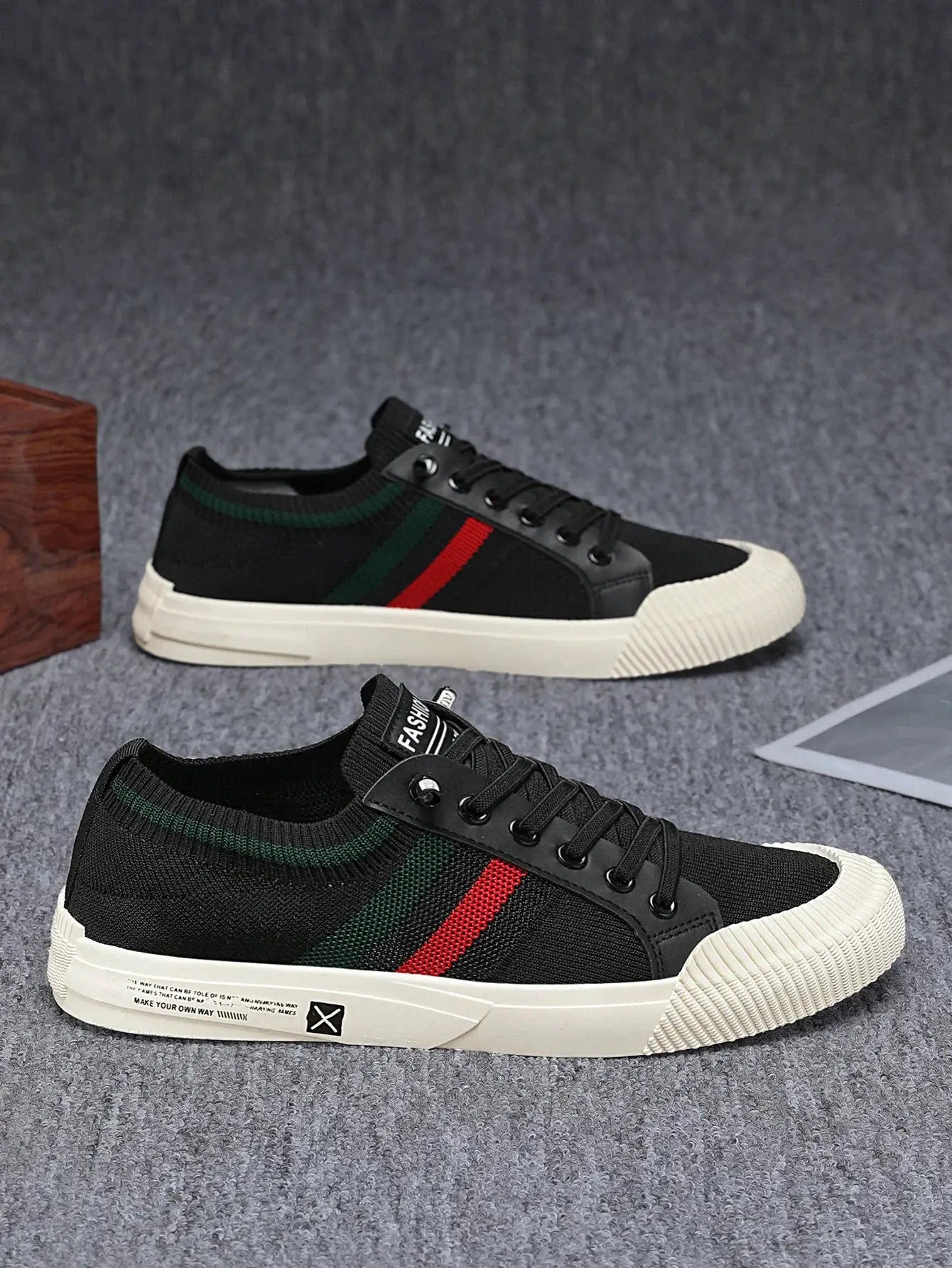 Men's casual knit sneakers, black with green and red stripe and white sole; two pairs
