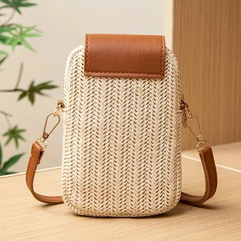 Casual street style mini crossbody phone bag by Simples Market; beige woven straw with brown leather flap and strap.