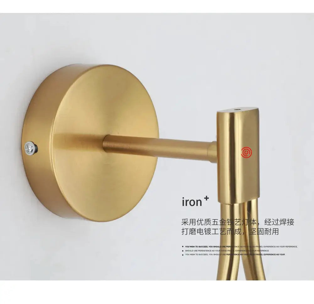 Gold metal wall lamp with circular backplate and horizontal arm, modern minimalist LED fixture