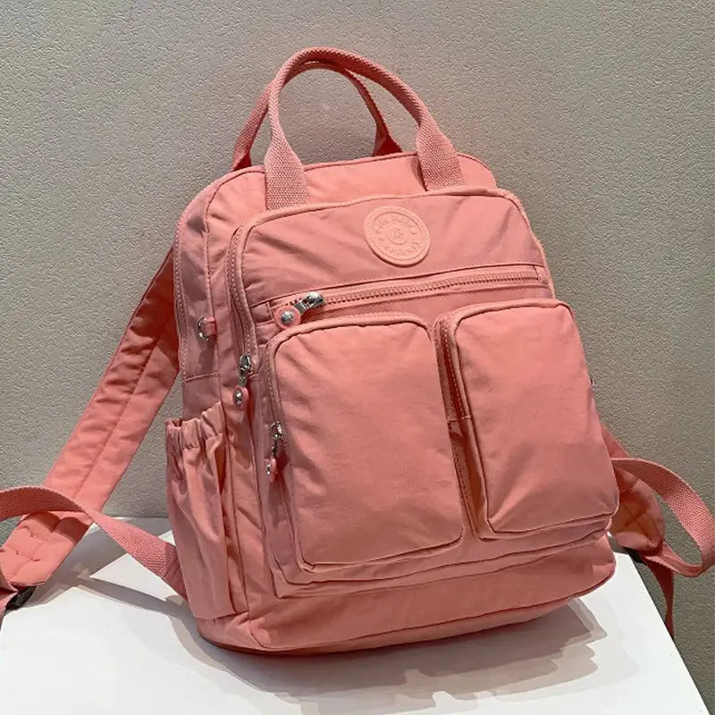 Backpack Simples Market pink waterproof nylon with multiple pockets and top handles