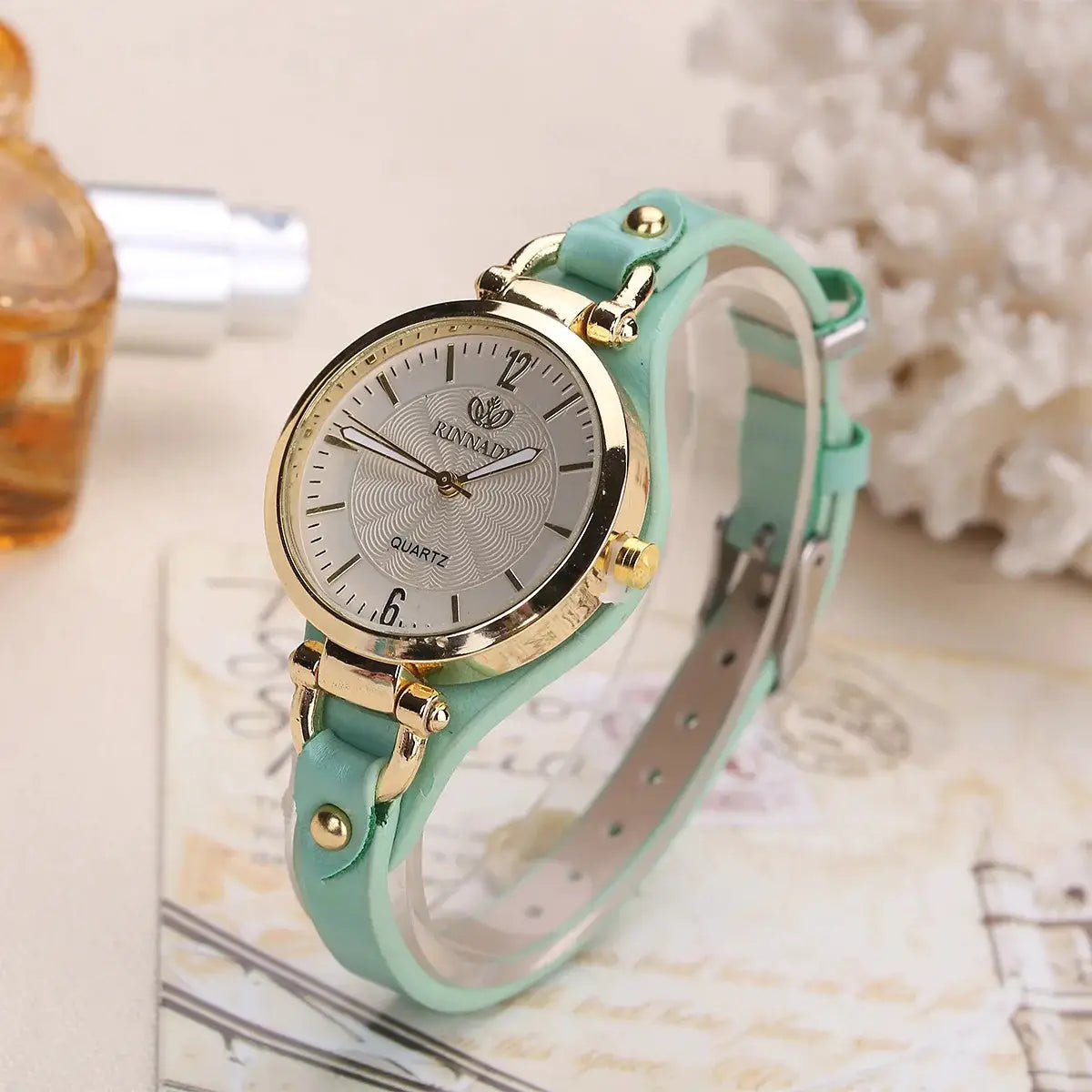 Women's quartz watch with mint green leather strap and gold-tone case