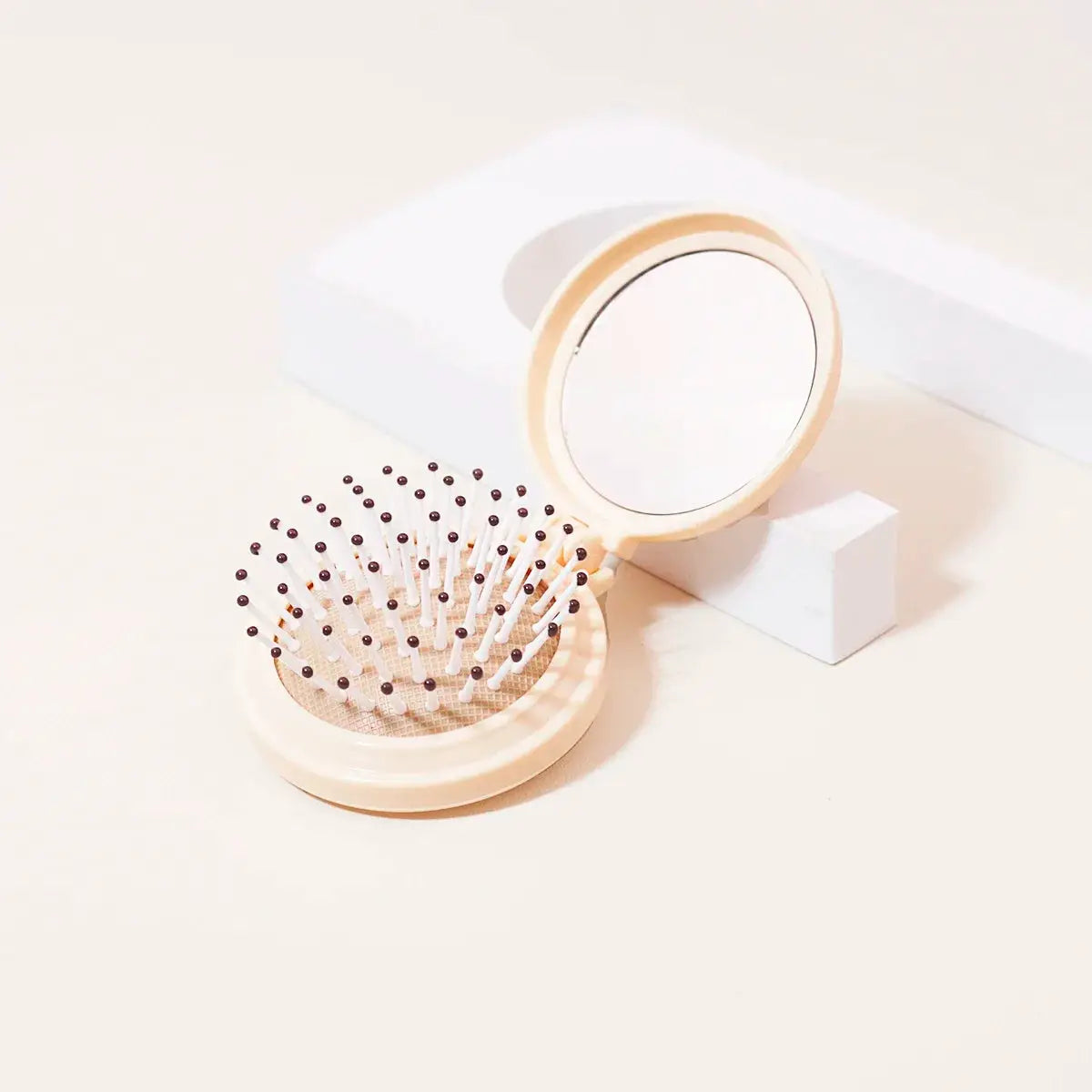 Simples Market mini folding mirror with built-in anti-static hair brush, beige travel styling tool