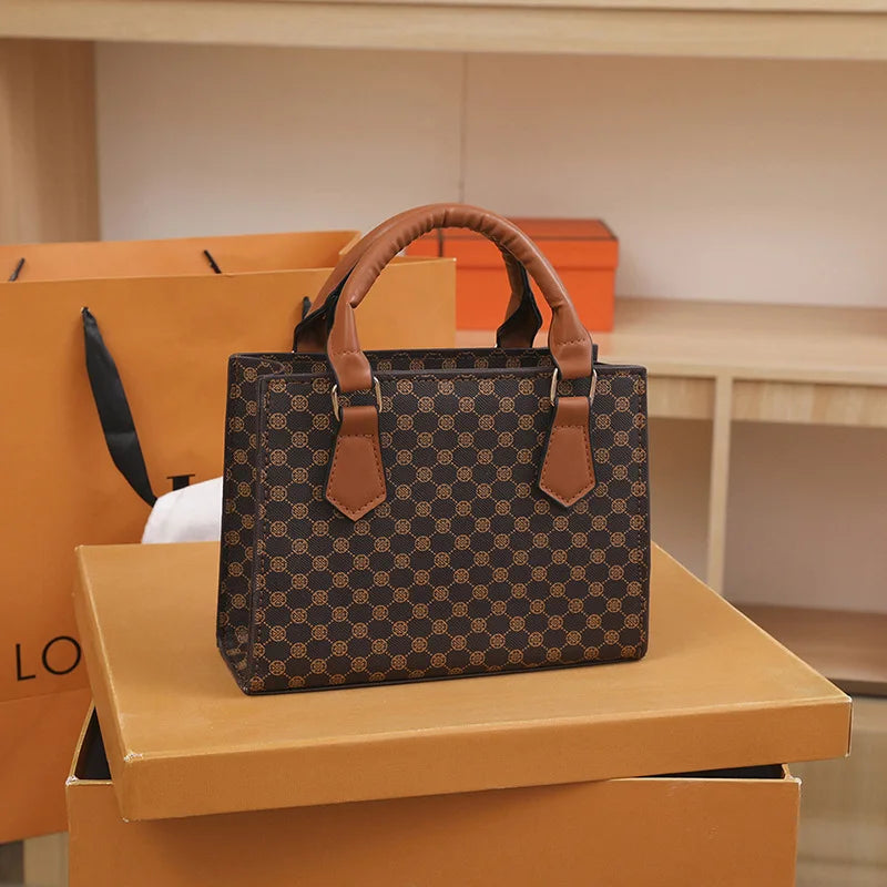 Fashion square small top-handle bag in brown plaid PU leather with tan handles.