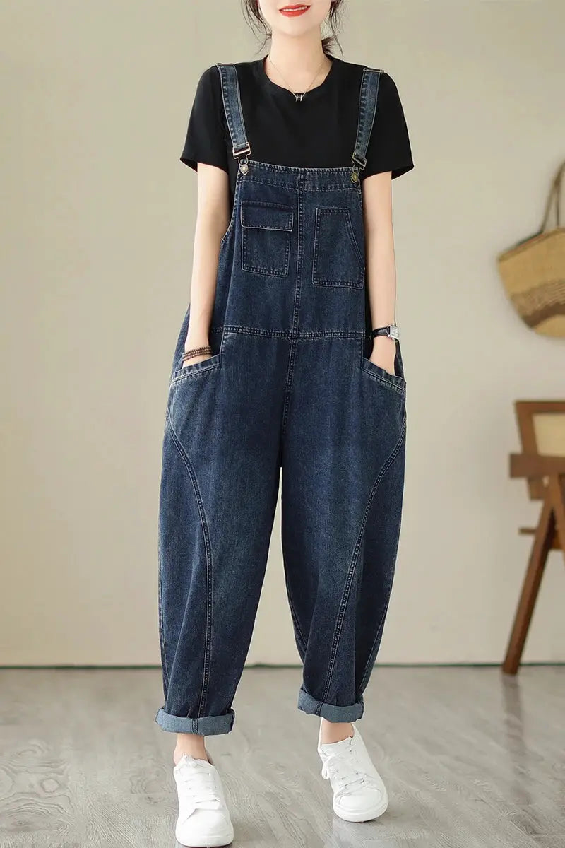 Women's blue denim overalls with suspenders, multi-pocket cargo style, relaxed fit with rolled cuffs.