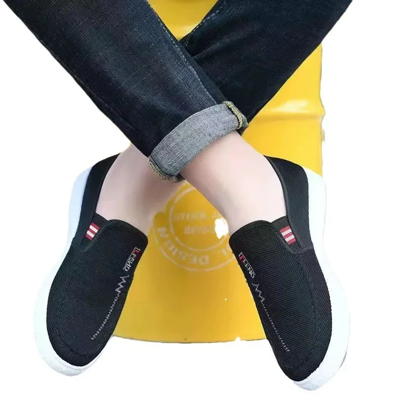 Pair of Simples Market men's black breathable canvas slip-on sneakers with white sole