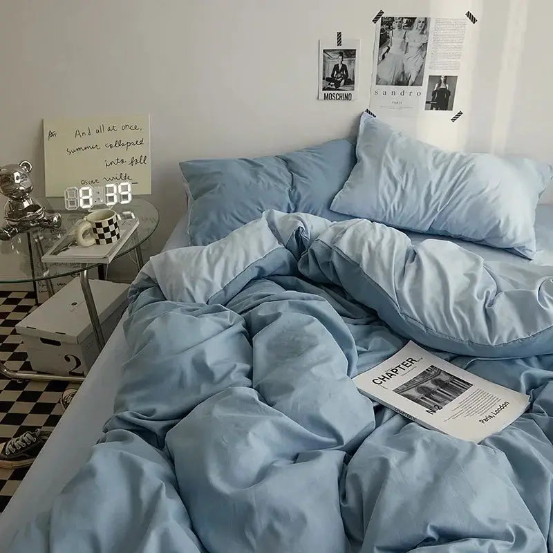 Solid light-blue cotton bedding 4-piece duvet set by Simples Market for dorm rooms on a bed with blue pillows