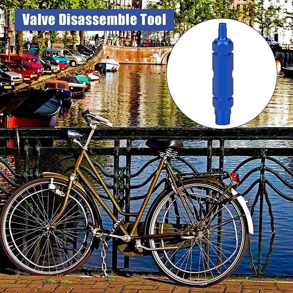 Blue valve core remover tool for Presta/Schrader, tire repair wrench beside a bicycle by a canal