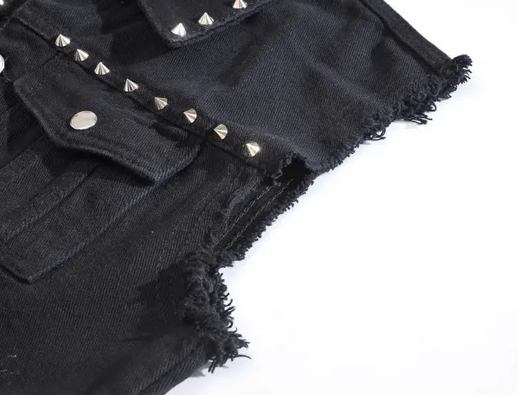 Black denim sleeveless vest with silver pyramid studs, front pockets, and frayed hem.