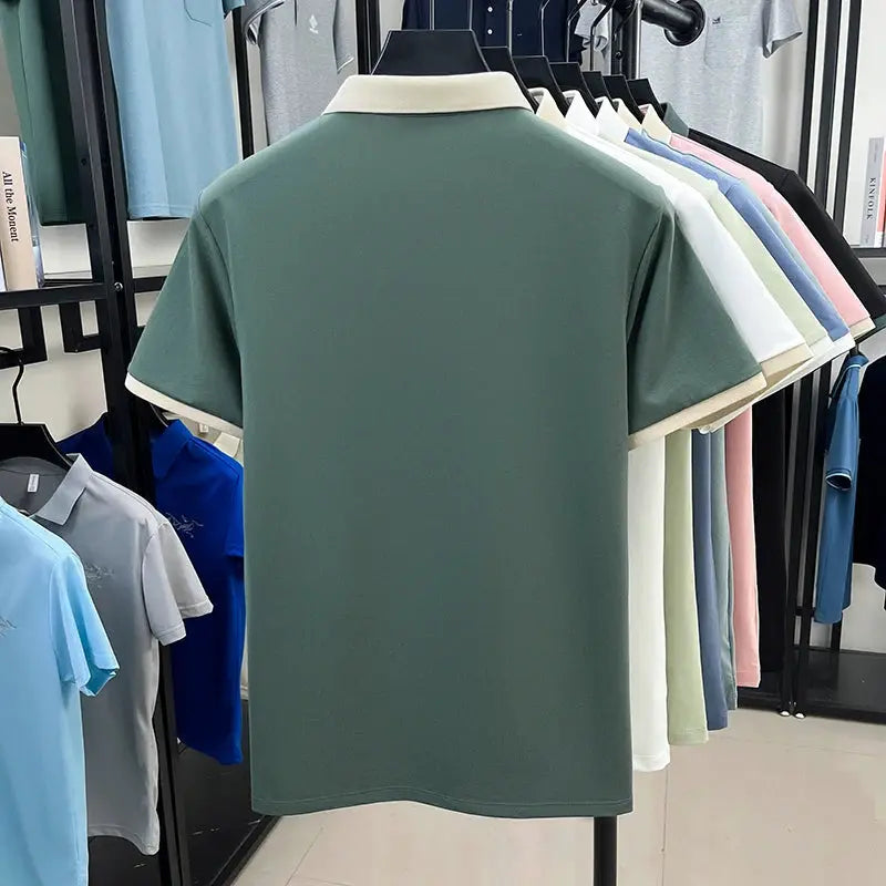 Designer silk-cotton polo shirt for men in green with cream collar, short sleeves, on display among other colored polos.