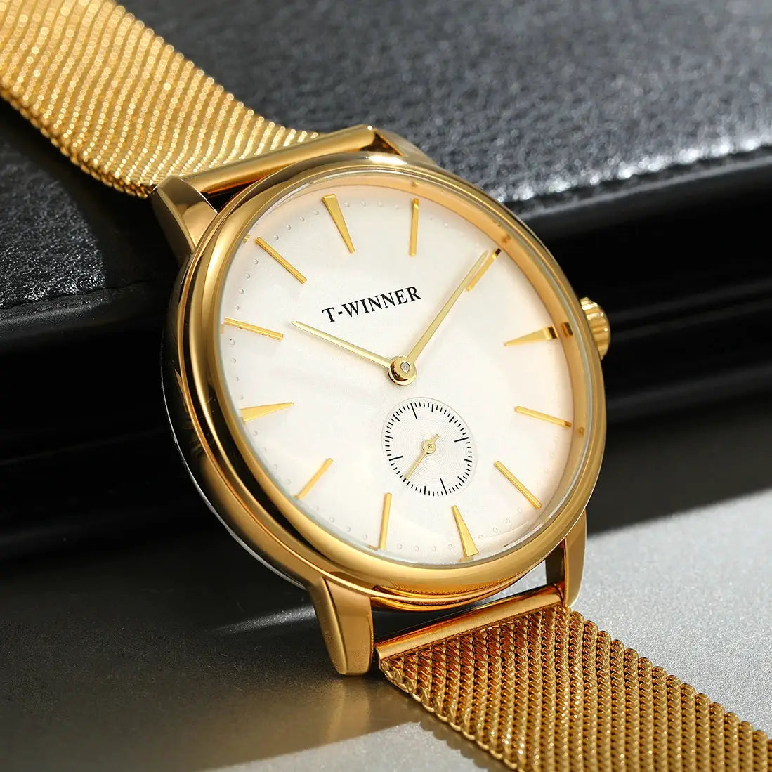 Wristwatch with gold-tone mesh strap, white dial with gold indices and small seconds subdial, T-WINNER