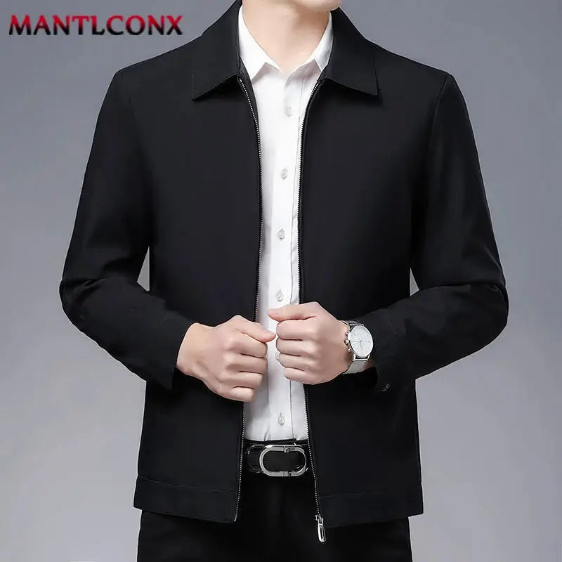 Men's black zip-front blazer; solid casual/formal jacket by MANTLCONX worn over a white dress shirt.