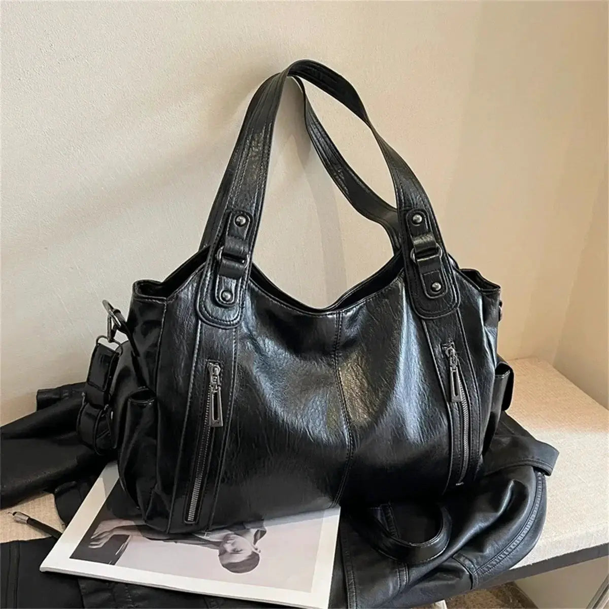 Black PU leather shoulder bag with top handles and front zip pockets
