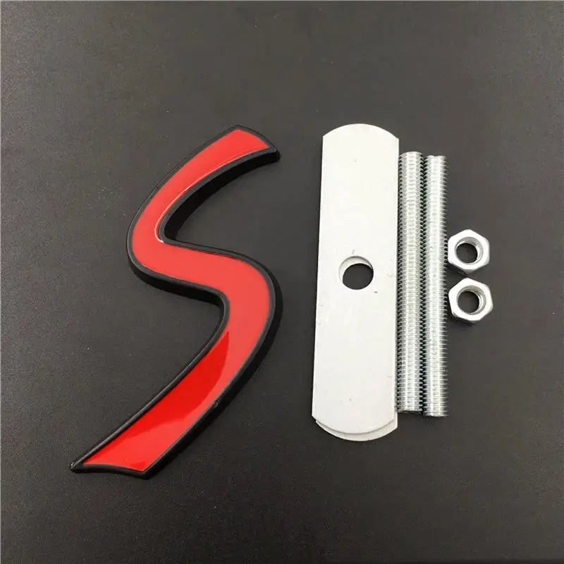 3D metal S car front grille emblem with red insert and black edge, plus mounting plate, threaded studs and nuts