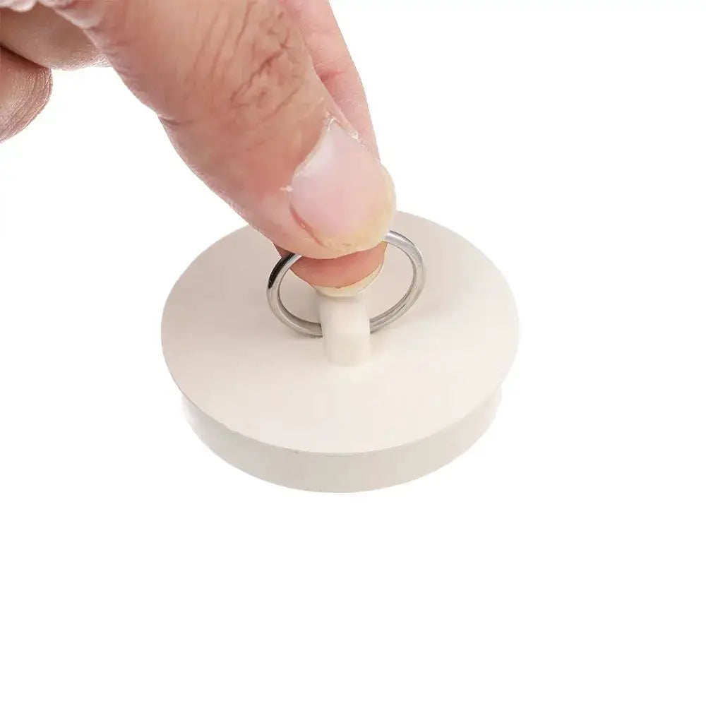 White rubber sink plug with a metal ring and plastic stem