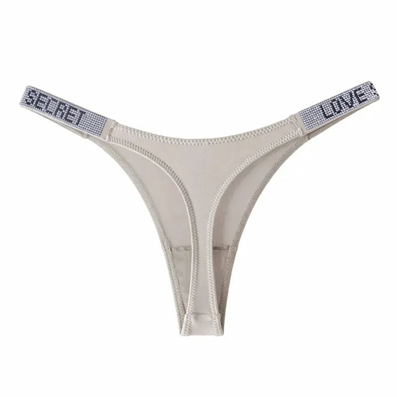 Low waist nude thong underwear with rhinestone straps reading SECRET and LOVE