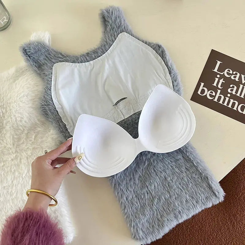 White molded padded bra cups on plush gray faux fur fabric