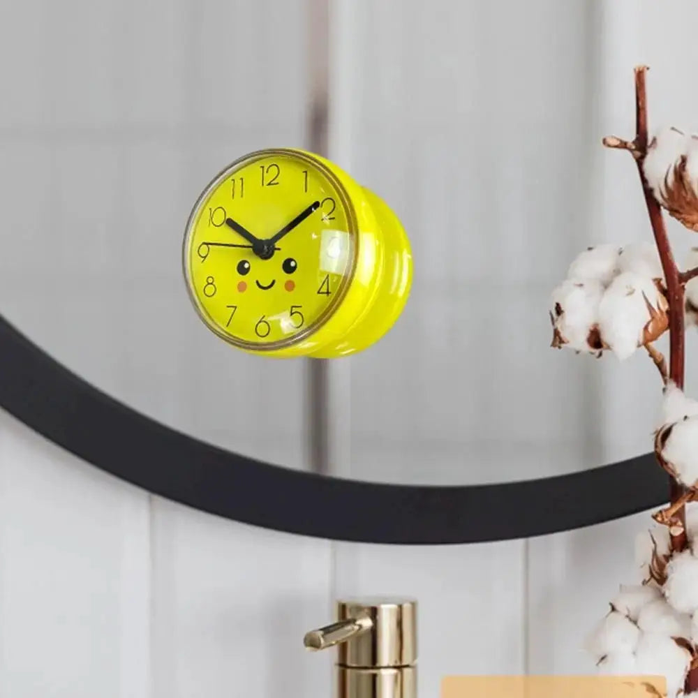 Mini yellow sucker wall clock with a cheerful smiley face for bathroom decor