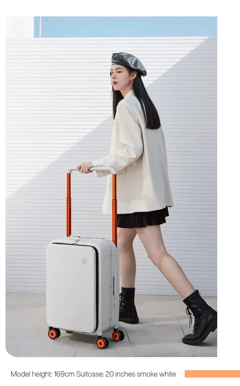 White 20-inch carry-on suitcase with orange telescoping handle and orange wheels