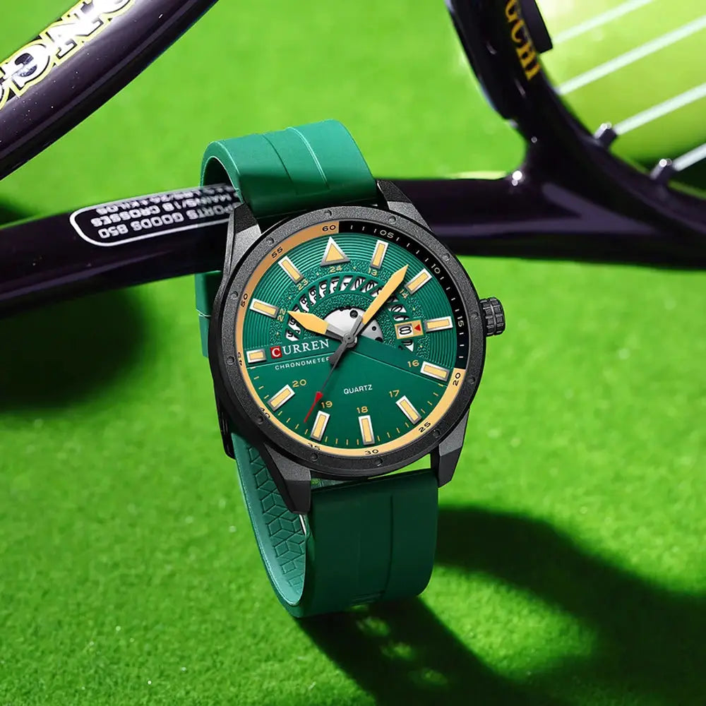 CURREN men's wristwatch with green dial, green silicone strap, black case, gold-tone hands and markers, date window.