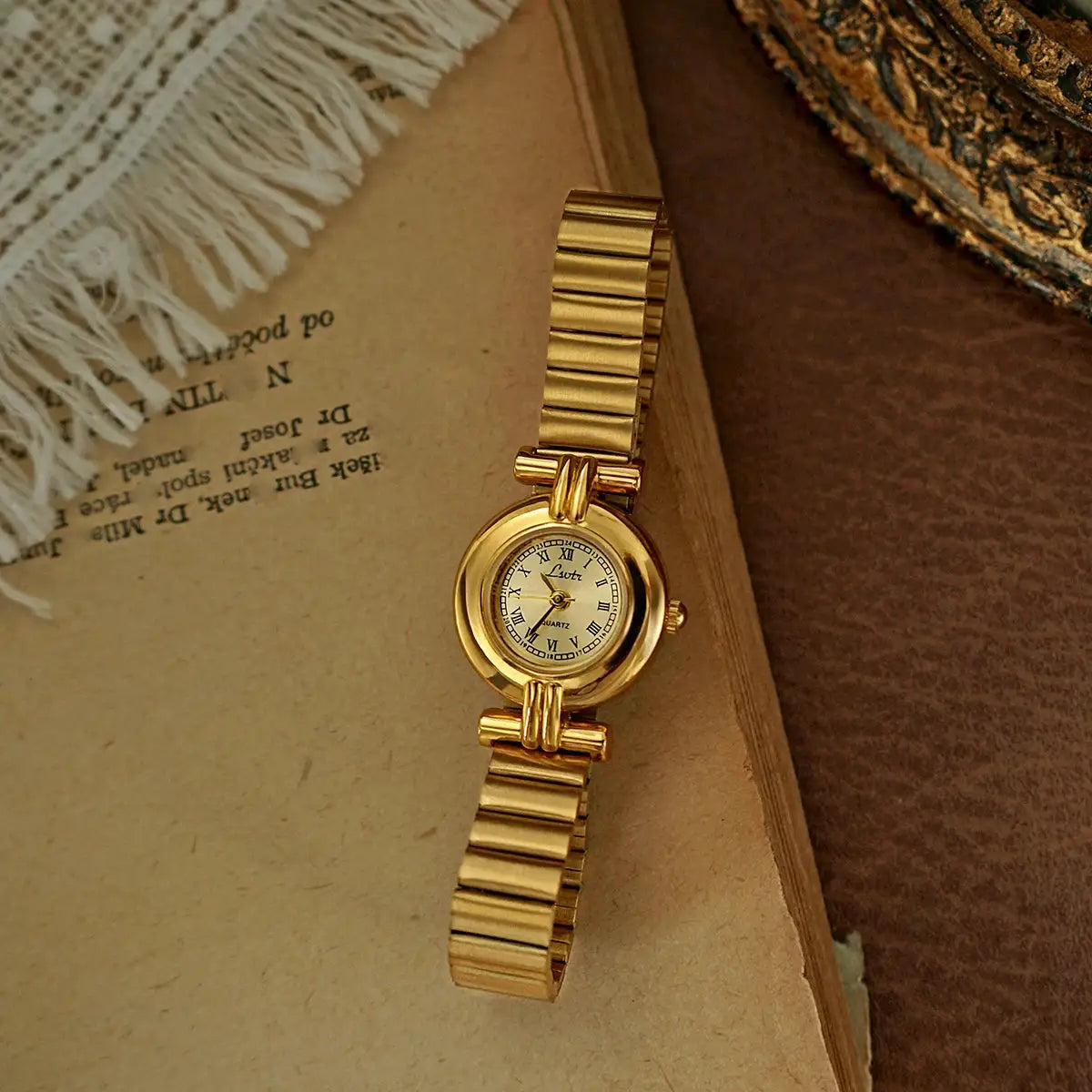 Gold-tone women's retro wristwatch with a small Roman numeral dial and link bracelet