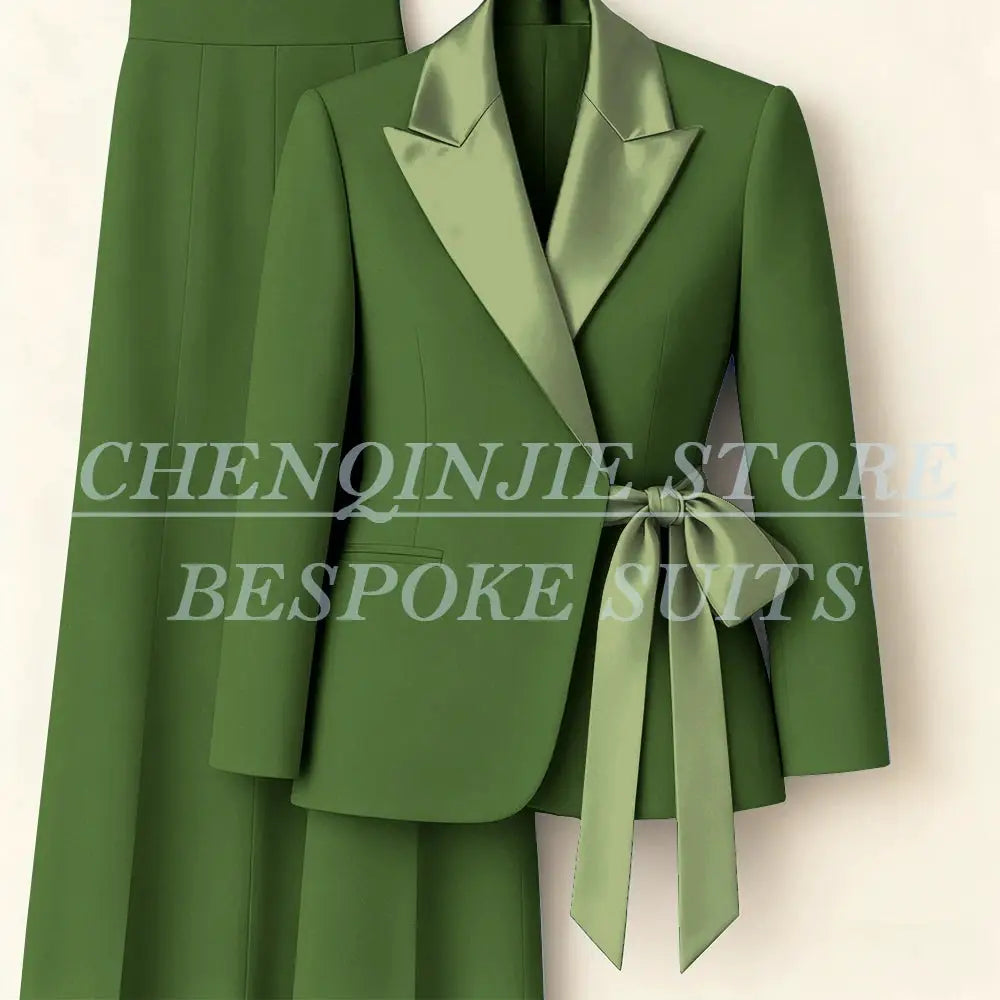 Women's green two-piece blazer suit with satin peak lapels and waist tie, matching pants