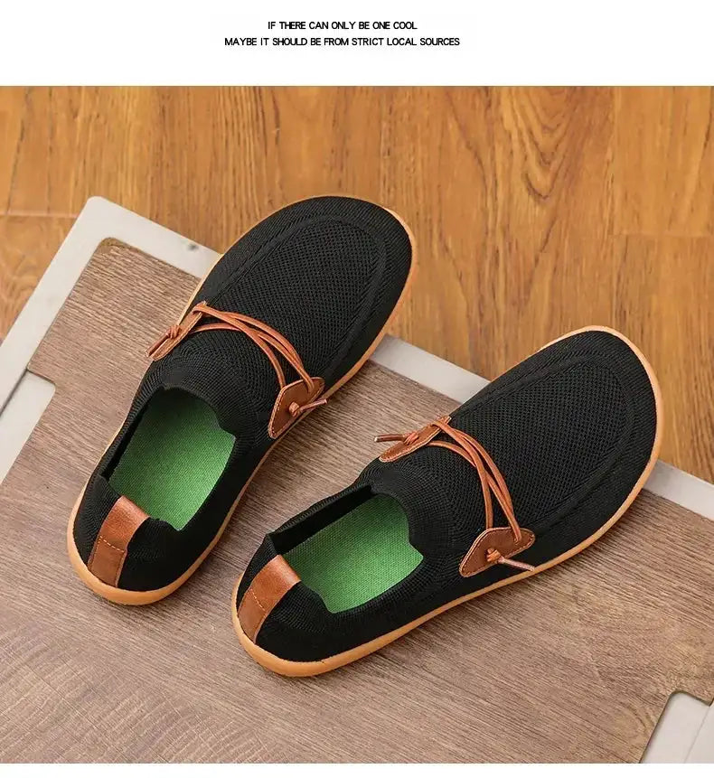 Barefoot shoes pair by Simples Market, black mesh uppers with tan leather laces and light brown sole trim.