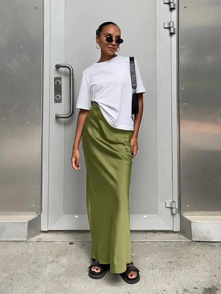 Olive green satin trumpet skirt, high-waisted and full-length.
