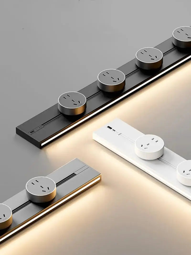 Embedded track socket kitchen power rail with multiple round universal outlets on black, white, and gray modules.