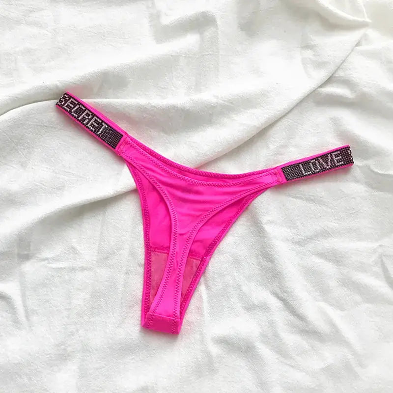 Pink low-rise thong with rhinestone-embellished waistband; T-back style.