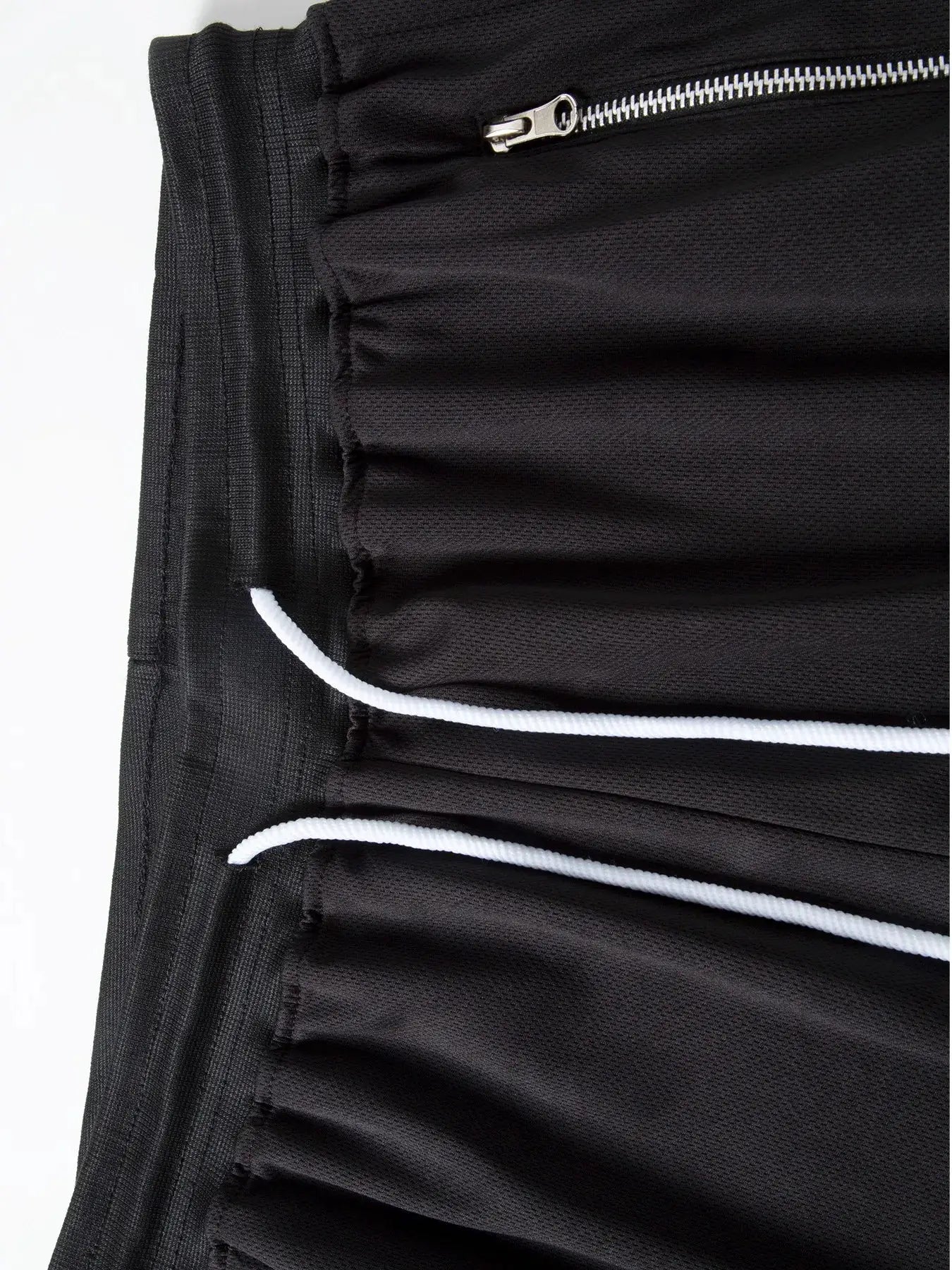 Men's black athletic shorts with white drawstrings and zippered pocket.